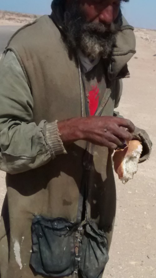 This man is very grateful for a small morsel of bread.